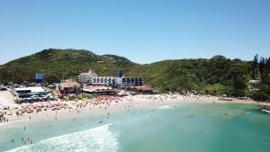 a group of people on a beach in the water at Cris Hotel in Florianópolis