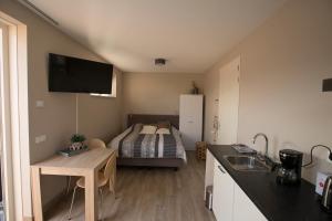 a small kitchen with a bed in a room at Zon Zee Zoutelande in Zoutelande