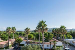 an aerial view of a town with palm trees at Riva Nuova Camping Village in Martinsicuro