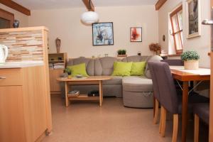 a living room with a couch and a table at Apartman Sverana in Velké Karlovice