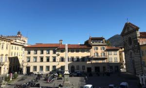 a group of buildings with motorcycles parked in a courtyard at Dimora 16 Rooms & Garden in Prato