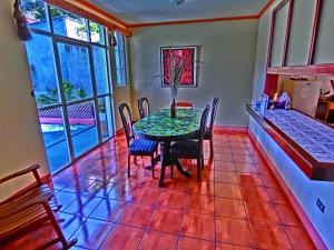 a dining room with a table and chairs at Hotel El Sol in Panajachel