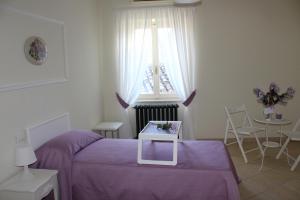 Postel nebo postele na pokoji v ubytování B&B Bouquet di fiori