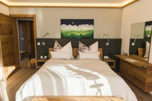 a bedroom with a large bed and a bathroom at Trendguide Suites by Alpine Host Helpers in Kirchberg in Tirol
