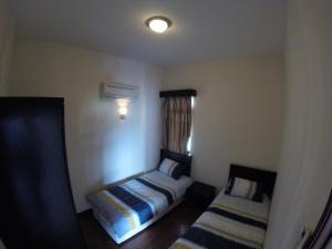 a small room with a bed and a window at 3 Bedrooms at Lagoon Park Resort in Melaka
