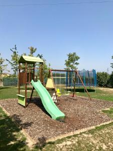 a playground with a green slide in a park at Ca' Borgo delle Rane in Pernumia