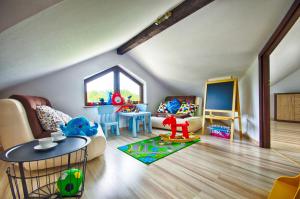 a living room with a couch and a table at Apartamenty Pod Dębem in Wicie