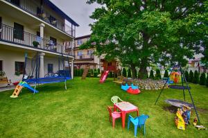 a yard with a bunch of playground equipment in it at Apartamenty Pod Dębem in Wicie