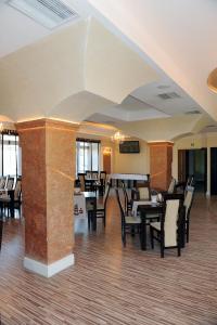 a restaurant with tables and chairs in a room at Restauracja Hotel Imperial in Jasło