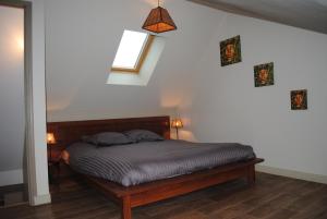 a bedroom with a bed in a room with a window at Gite le Sainte Mère Eglise in Sainte-Mère-Église