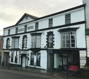 a white building on the side of a street at The Castle Lodge in Tredegar