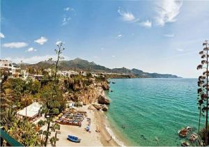 a view of a beach with people in the water at Apartamento Steffi - Centro de Nerja in Nerja