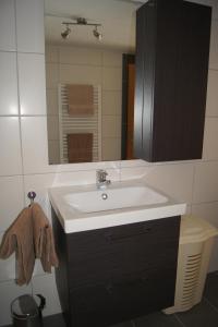 y baño con lavabo blanco y espejo. en Gästehaus Alberta, en Navis