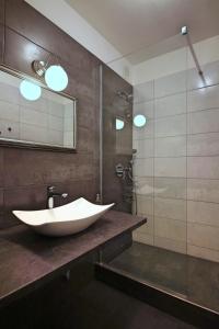 a bathroom with a large white sink and a shower at Near Castle ☆ free bikes ☆ terrace in Prague