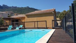 a swimming pool next to a house at Etape Cathare in Duilhac