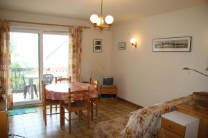 a living room with a table and a couch at Appartement La Marmotte in Font-Romeu