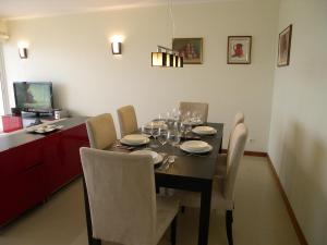 a dining room with a table with wine glasses on it at Lovely Apartment Alvor in Alvor