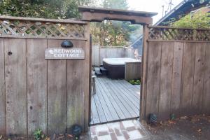 a wooden gate with a sign that reads backyard coffee at Redwood Cottage in Mendocino