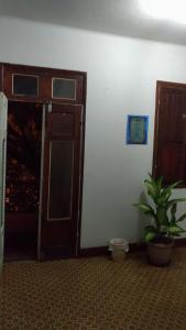 a room with a door and a potted plant in it at Hotel Indaiá in Governador Valadares