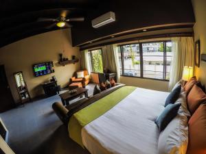 a bedroom with a large bed and a large window at Humuya Inn in Tegucigalpa