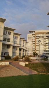 a row of large apartment buildings in a park at Condominio Costamar in Coquimbo