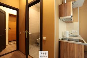 a bathroom with a sink and a toilet and a door at Apartment E&J in Krasnoyarsk