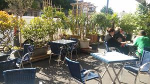 a group of people sitting at tables and chairs at La Caravelle in Riom