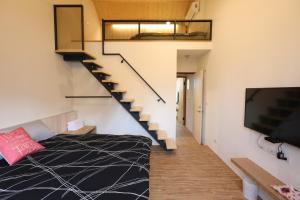 a room with a bed and a staircase at 舒室民宿 in Tainan