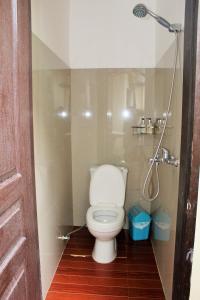 a bathroom with a toilet and a shower at Ashok Homestay in El Nido