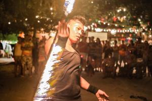 a young man walking down a street at night at Sarikantang Resort & Spa, Koh Phangan in Haad Rin +37 photos