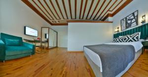 a bedroom with a bed and a couch and a television at Istanbul Life Hotel in Istanbul