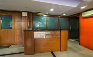 a room with a counter with wood paneling at Shoba Suites-Kammanahalli in Bangalore
