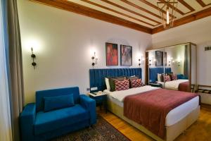 a bedroom with a bed and a blue chair at Istanbul Life Hotel in Istanbul