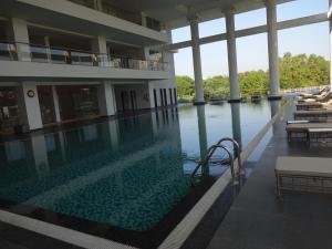 a large swimming pool in a building with water at Amanora The Fern Hotels & Club in Pune