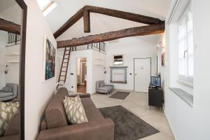 a living room with a couch and a tv at ReArduinoIvrea in Ivrea