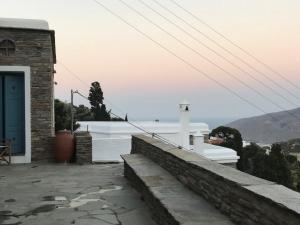 a house with a blue door and a view of the ocean at Petra Traditional House in Episkopión