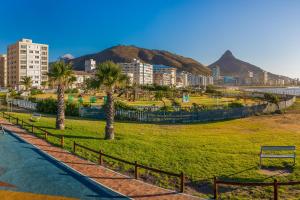 a park with palm trees and buildings in a city at The Odyssee 409 in Cape Town