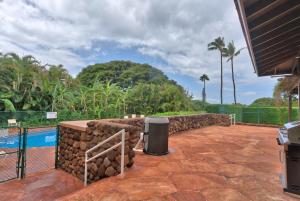 a patio with a stone retaining wall and a pool at Kaanapali Plantation Condominiums in Kaanapali