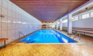 a large swimming pool in a building at Appartement Petit in Saalbach-Hinterglemm