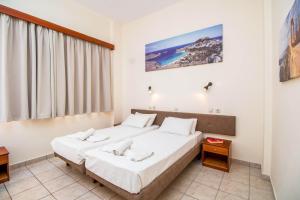 een hotelkamer met 2 bedden en een raam bij Filmar Hotel, Ixia, Rhodes in Ixia