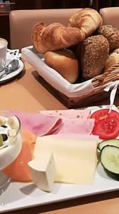 a plate of cheese and pastries on a table at Hotel Garni Italia in Bühl