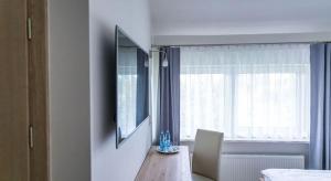 a dining room with a table and a window at Oleńka in Kutno