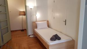 a small room with a bed and a lamp at Errathens Apartments - Athens Center in Athens
