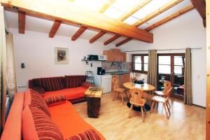 a living room with a couch and a table at Appartements Berger Kitzbühel in Kitzbühel