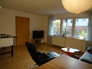 a living room with a table and a television at Gästewohnung Leinetal in Alfeld