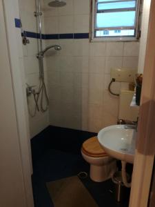 a bathroom with a toilet and a sink at Roof Top Studio in Athens