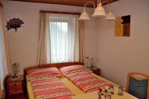 a bed in a bedroom with a window at Haus Jost Ingrid in Hermagor