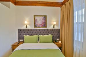 a bedroom with a large bed with green pillows at Istanbul Life Hotel in Istanbul