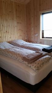 two beds sitting in a room with a window at Hekla Cabin 1 Volcano and Glacier View in Hella