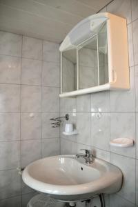 a bathroom with a sink and a mirror at Haus Jost Ingrid in Hermagor